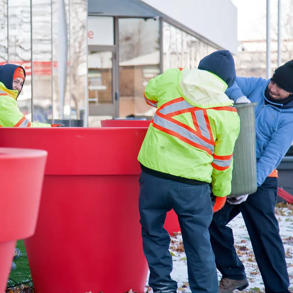 Garden city employees filling large planter pot